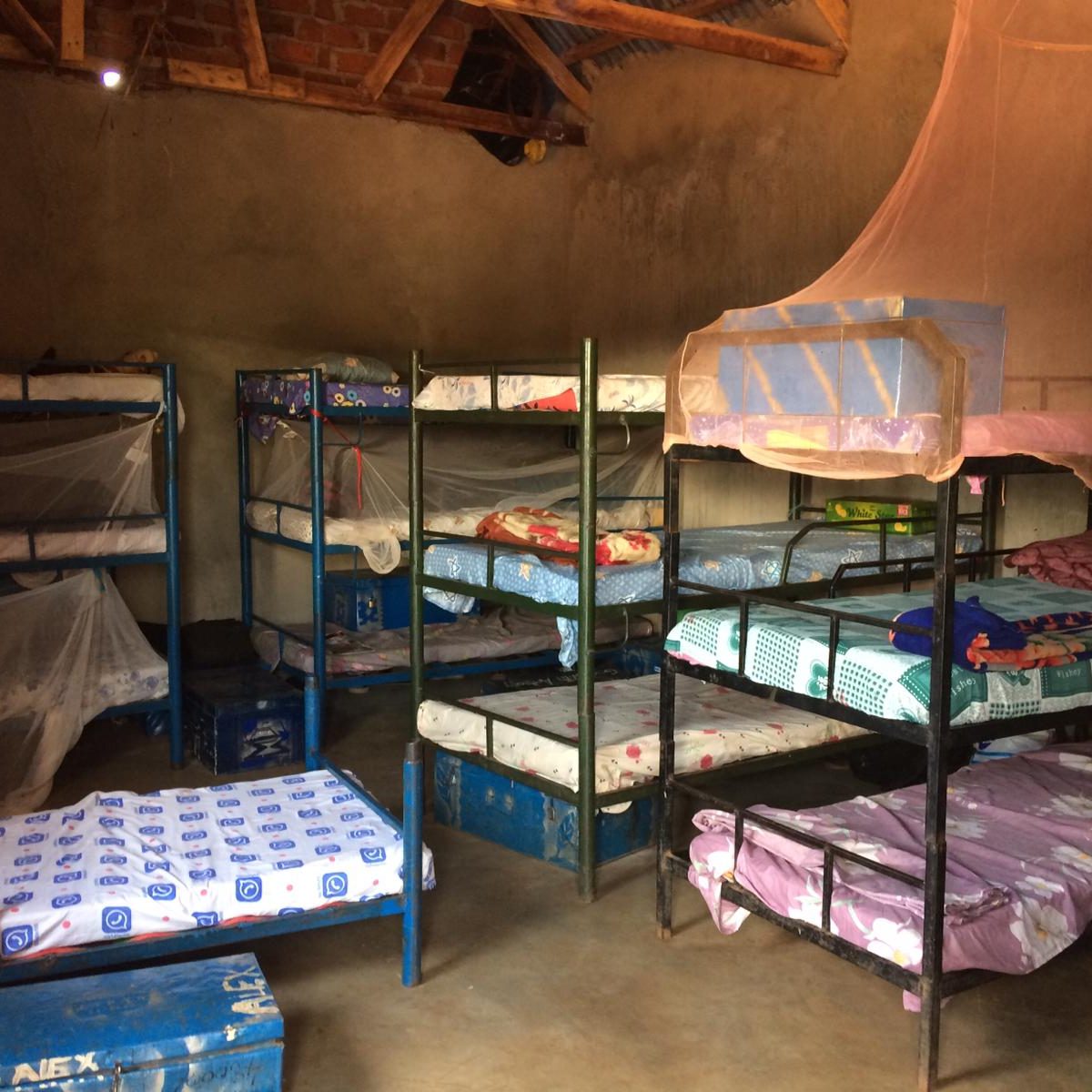 A dormitory, 2 children in each bed on triple bunks
