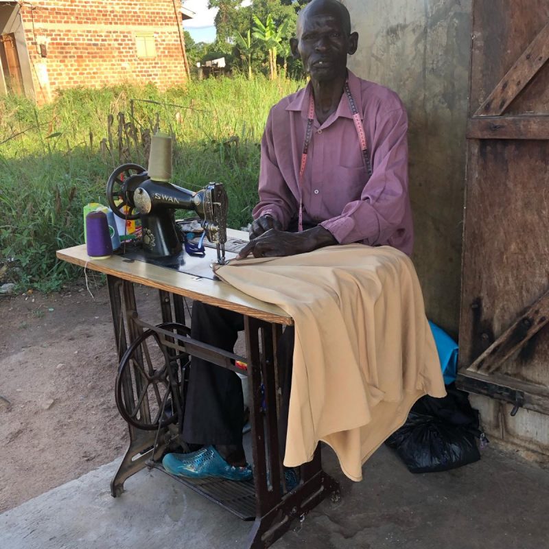 On the way home we saw this tailor working outside his home